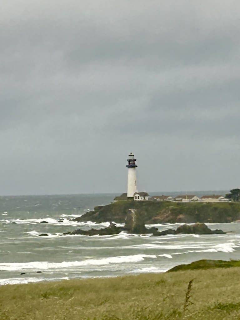 An image of the Point Montara Lighthouse taken from a distance on Highway 1, photo ©Kate Dana