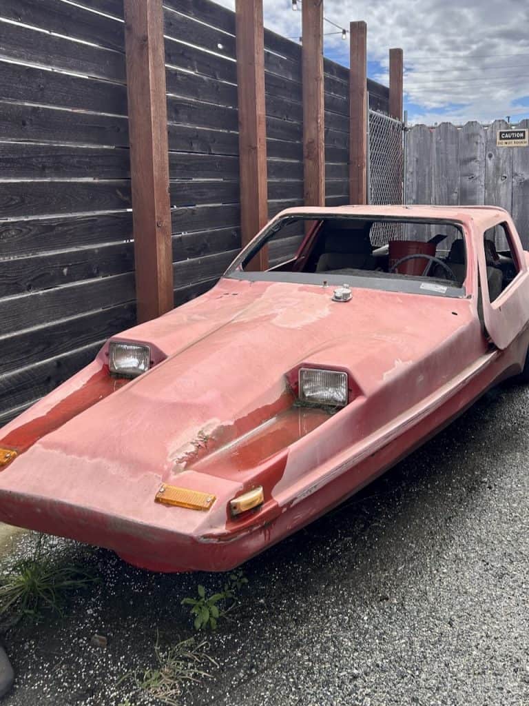 A strange red automobile in a lot near The Hangar in Watsonville, CA photo ©Kate Dana
