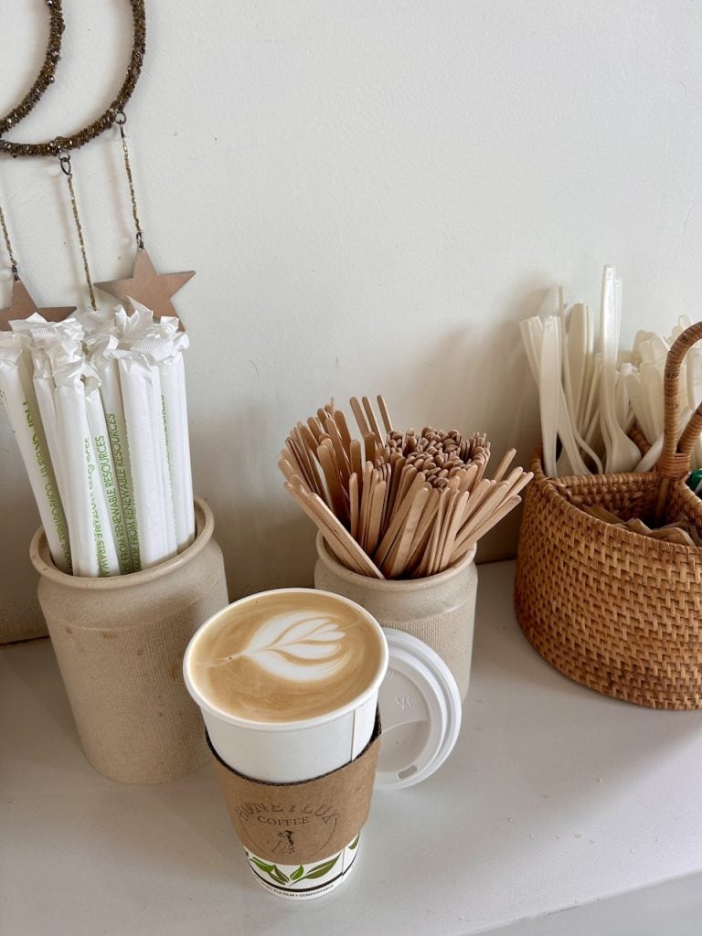 A creamy latte on a table at Honeylux coffee inside The Hangar in Watsonville, CA, photo ©Kate Dana