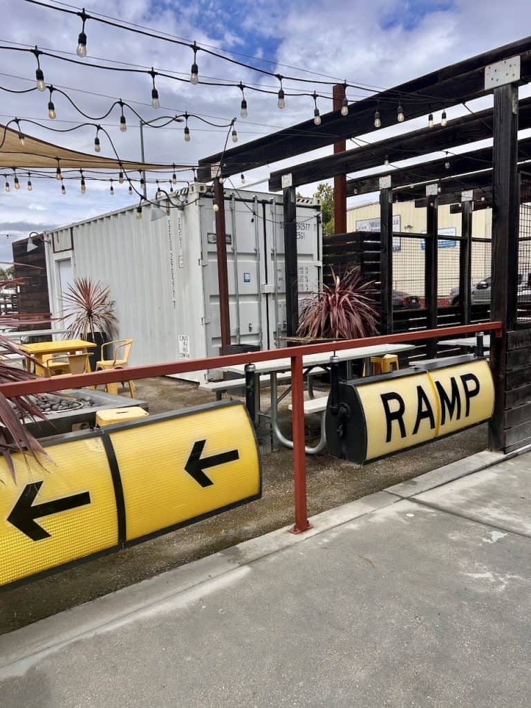 An airport-themed sign reading "ramp" at the entrance to The Hangar in Watsonville, CA photo ©Kate Dana