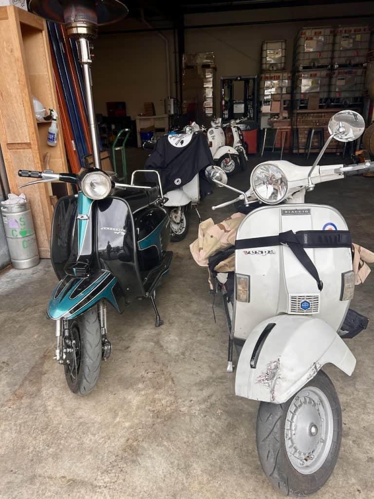 Vintage scooters line up inside a warehouse near the Santa Cruz Cider Company in Watsonville, CA, photo ©Kate Dana