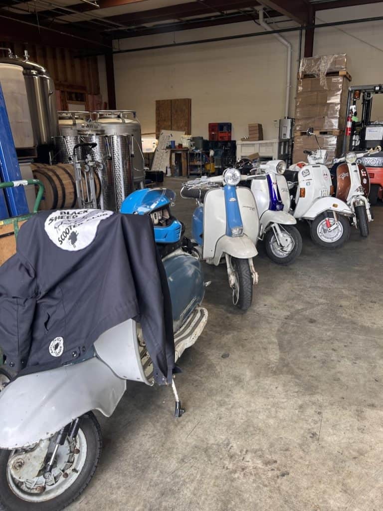 Vintage scooters line up inside a warehouse near the Santa Cruz Cider Company in Watsonville, CA, photo ©Kate Dana