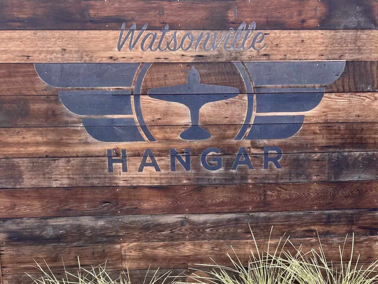 A wooden sign with an aviation theme announces The Hangar in Watsonville, CA, photo ©Kate Dana