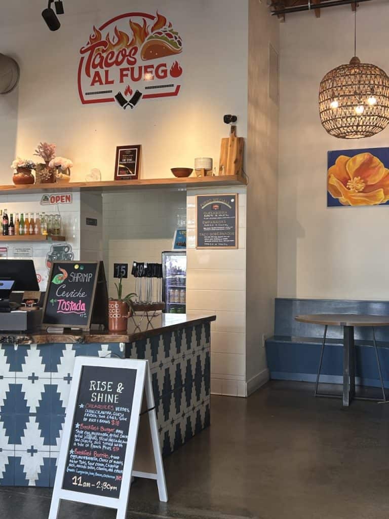 A counter announcing food specials at Tacos al Fuego at The Hangar in Watsonville, CA photo ©Kate Dana