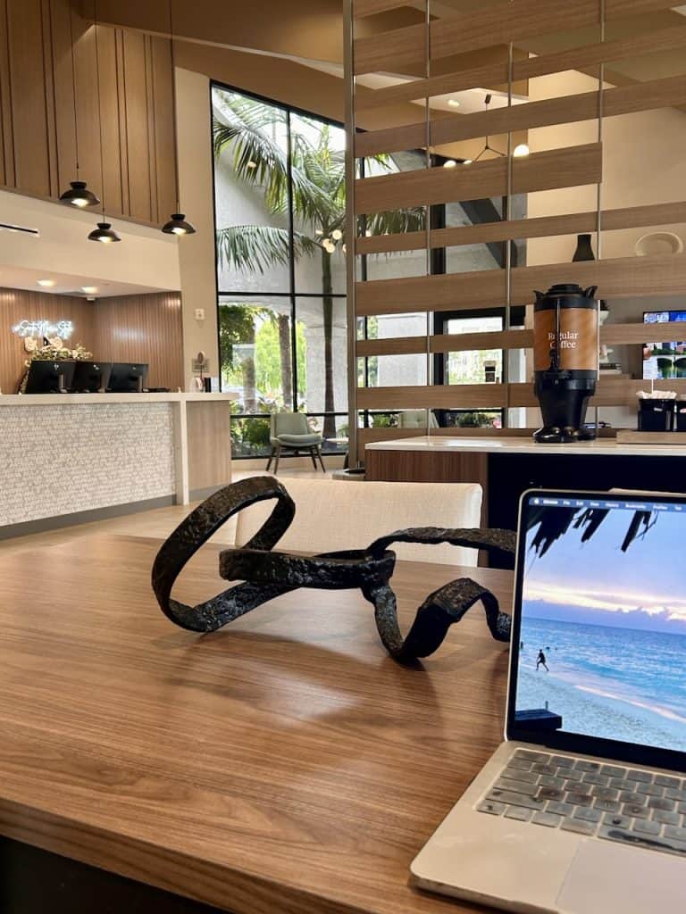 Remote work: A laptop computer on a table in the lobby of a hotel ©Kate Dana