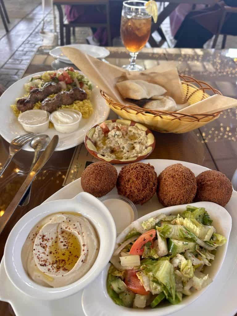 A table with plates of delicious Mediterranean food at a stylish restaurant, photo ©Kate Dana