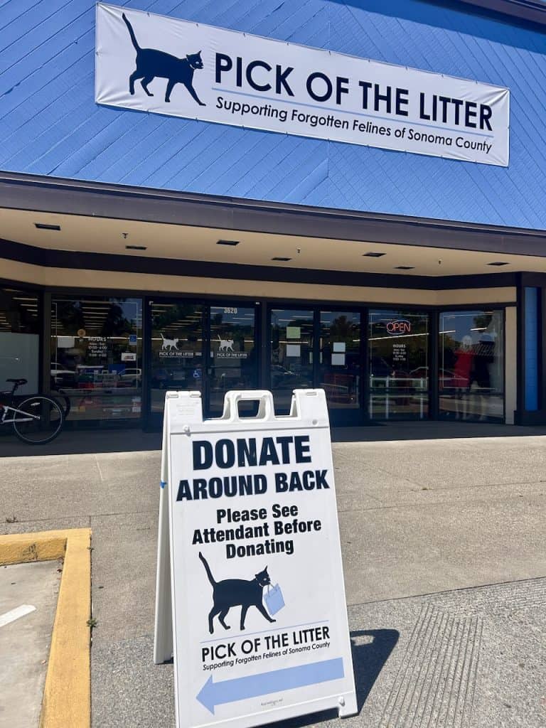 A sign in front of Pick of the Litter Thrift in Santa Rosa, CA, reads "Donate," photo ©Kate Dana