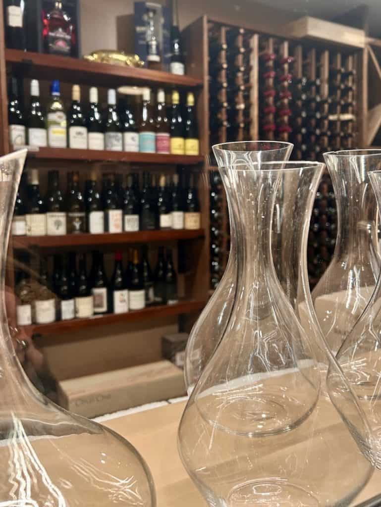 A view inside a wine pantry with hand-crafted glass decanters, photo © Kate Dana