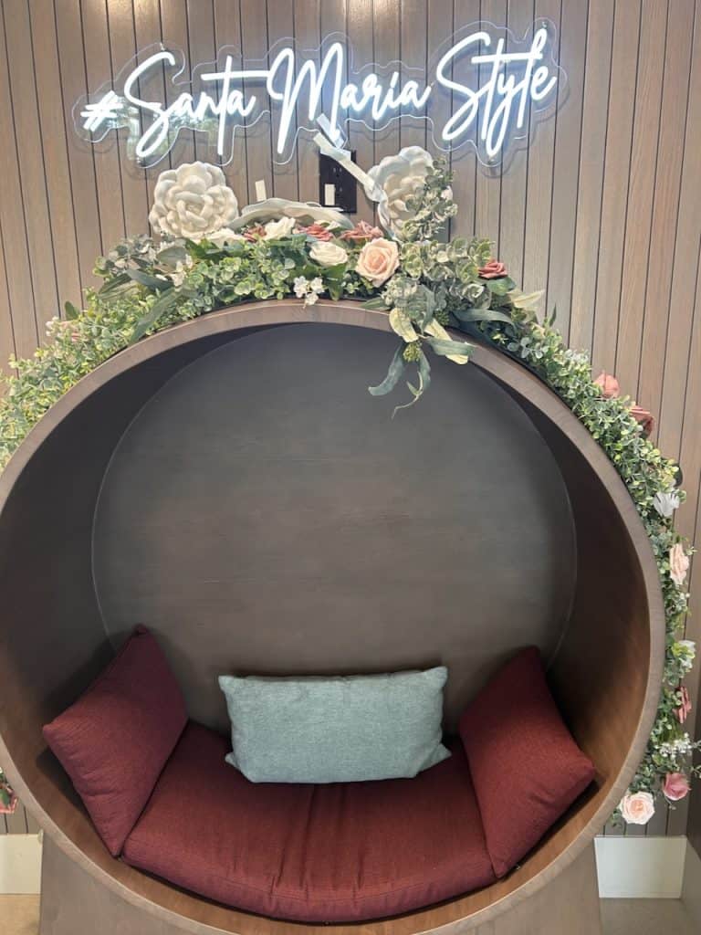 A neon script-style wall hanging over a barrel chair announces "Santa Maria Style" photo ©Kate Dana