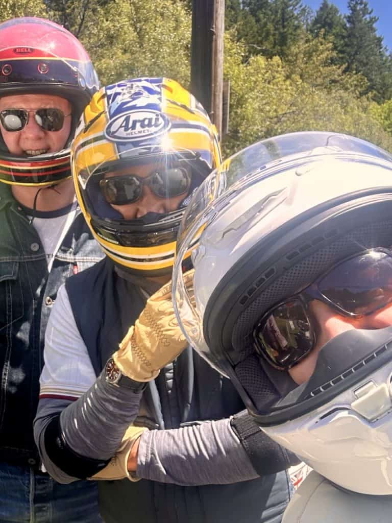 Three scooterists with full-face helmets smile for the camera in Santa Rosa, CA, photo ©Kate Dana